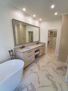 A beautiful bathroom with yellow lights and cabinets