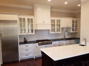 A kitchen with white cabinets and stainless steel appliances.