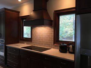 A kitchen with brown cabinets and a stove.