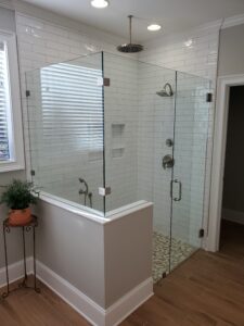 A bathroom with a glass shower enclosure.