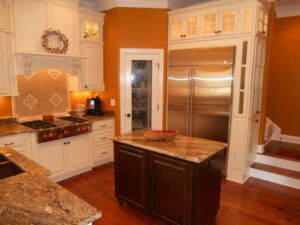 A kitchen with white cabinets and stainless steel appliances.