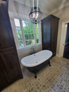 A bathroom with a bathtub and a chandelier.