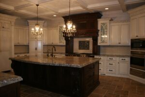 A large kitchen with a center island and chandelier.