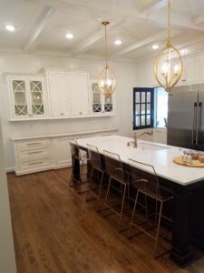 A kitchen with white cabinets and a large island.