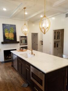 A kitchen with a large island and a fireplace.